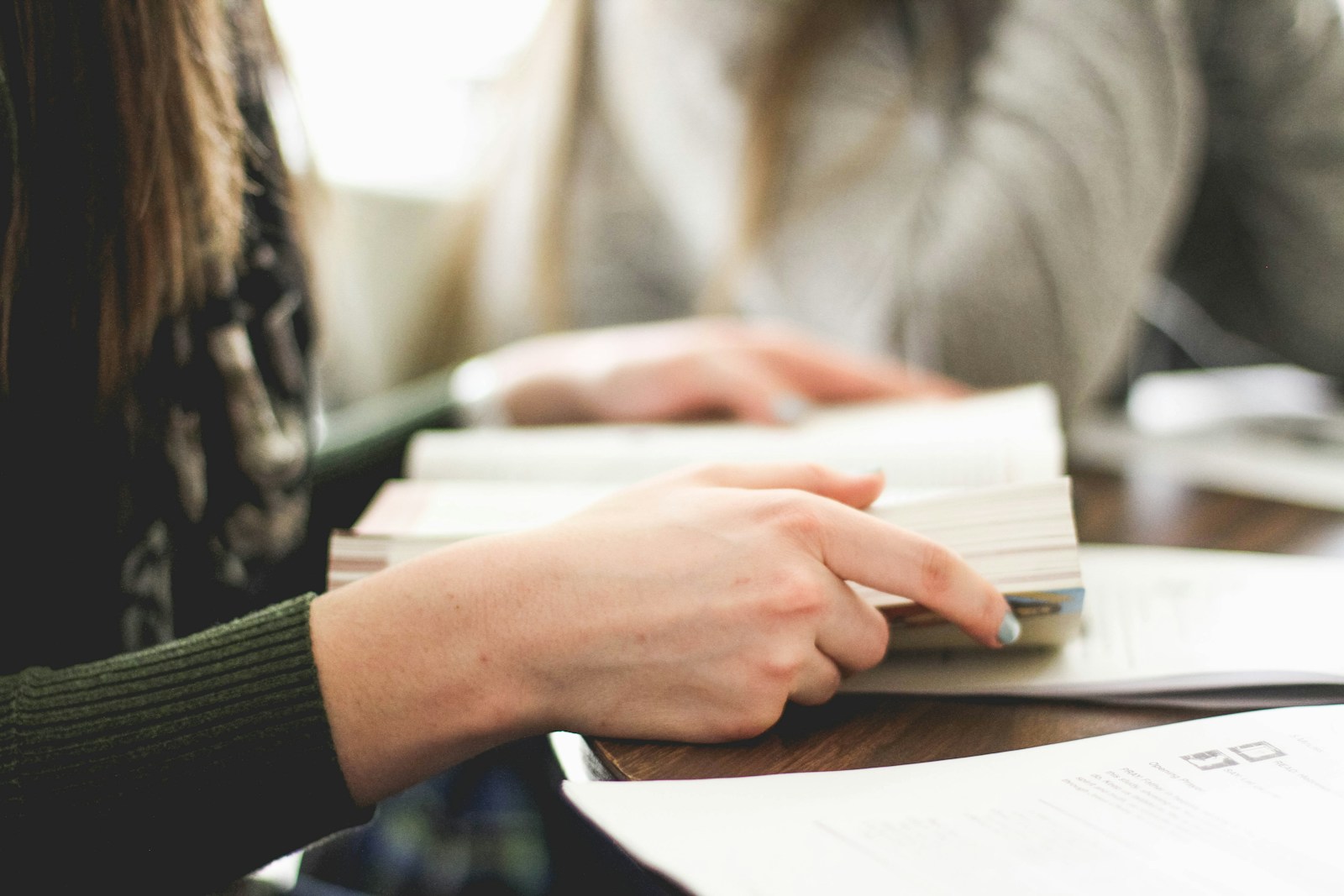 Photo by Sarah Noltner woman sitting on chair in front of table white reading book