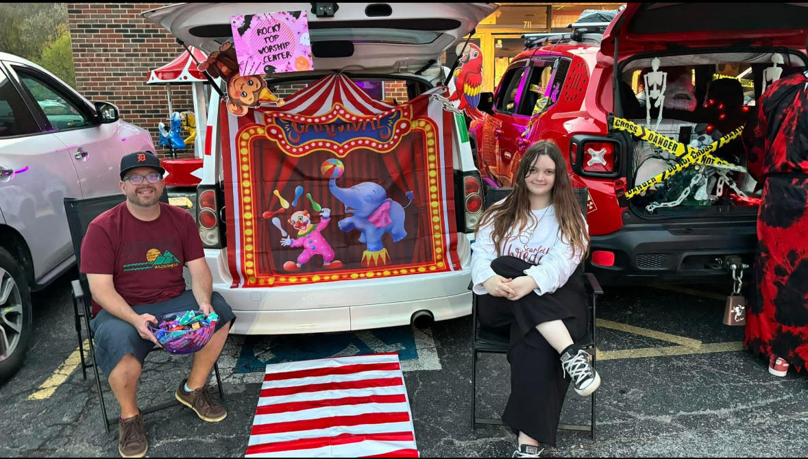 unnamed people sitting on chair in front of table while holding pens during daytime