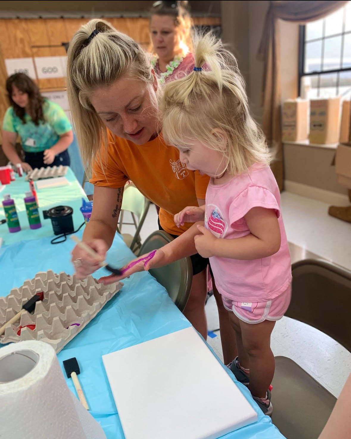 unnamed5 people sitting on chair in front of table while holding pens during daytime